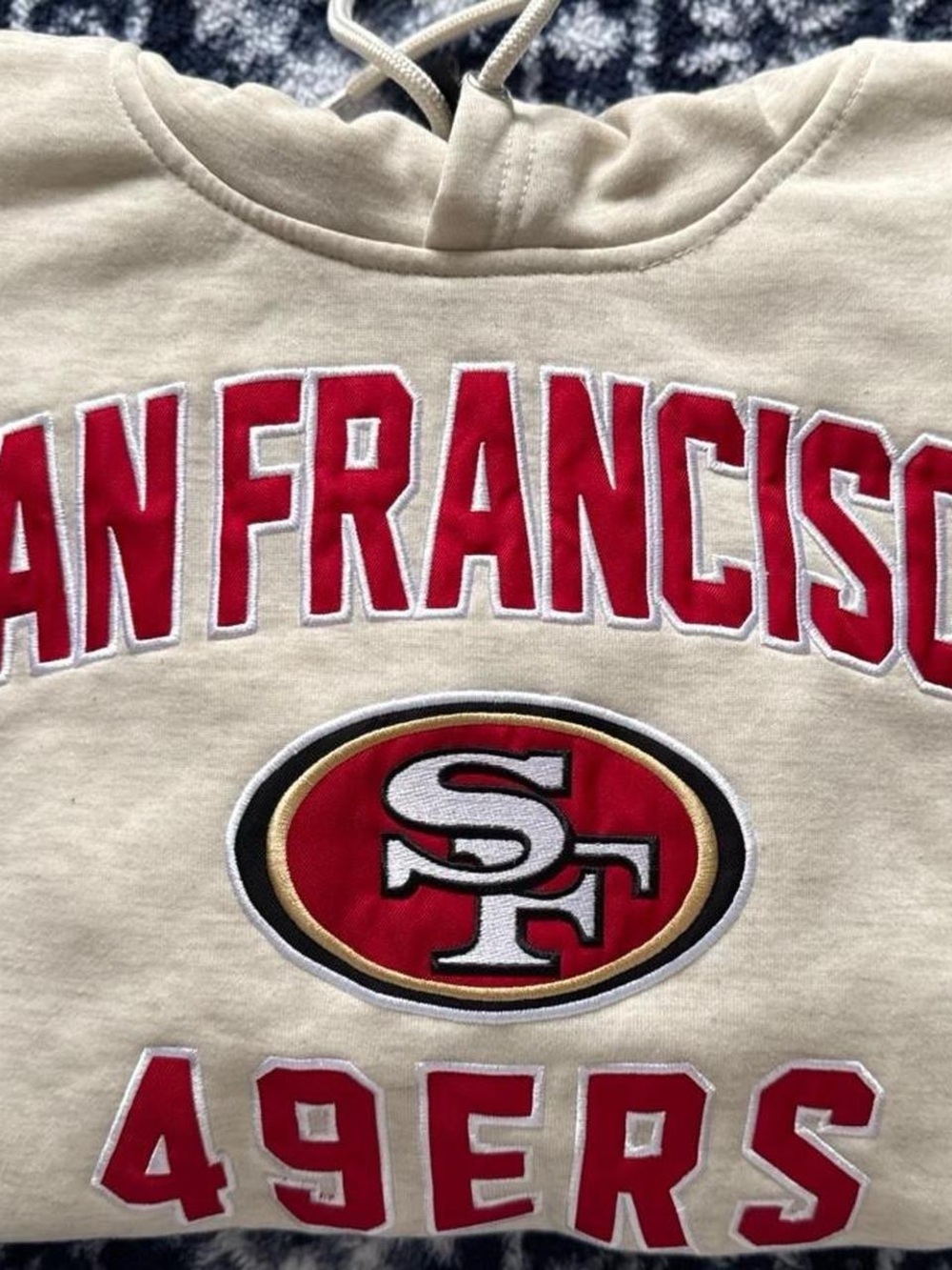 NFL Cream Hoodie with Black Logo Tag and Red Lettering